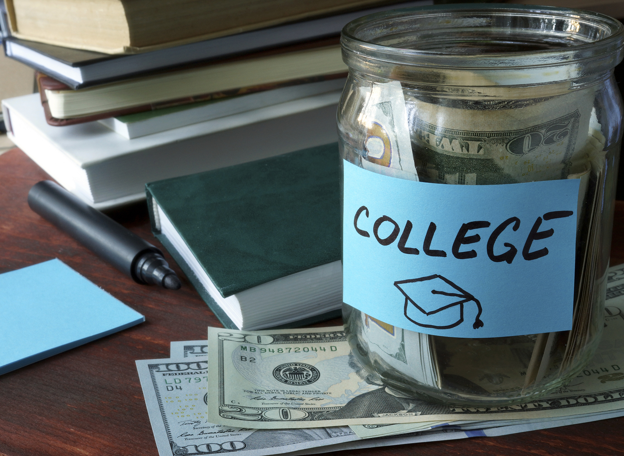 Jar with label and money on the table. Saving money concept.