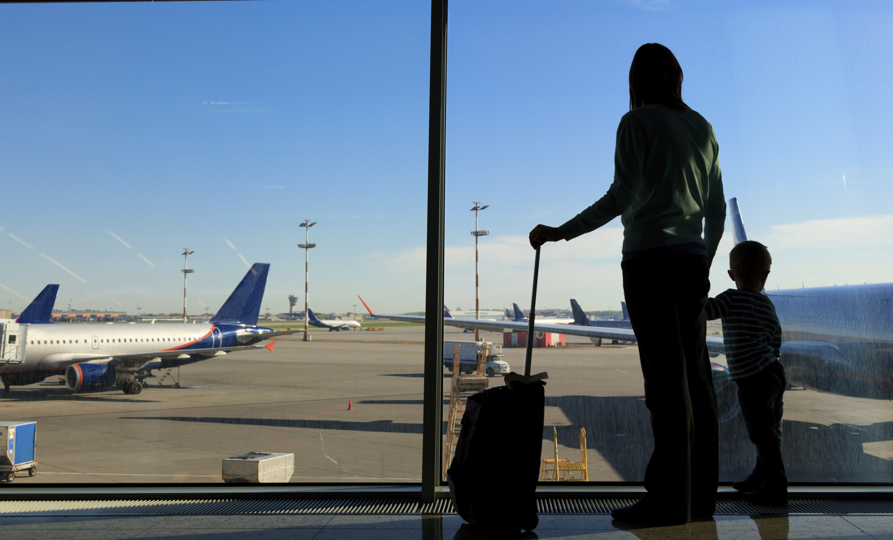 mother and son watching planes in the airport